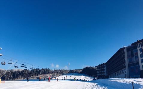 滑雪人滑雪人人类人物人儿童旅行度假冒险雪冬天冒险白色天空自然树松树建筑物建立酒店云