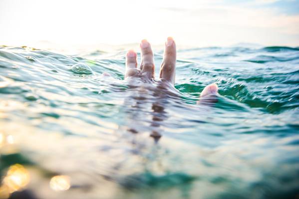 倾斜移位镜头摄影的人的手上方的水体和他的身体在水下高清壁纸