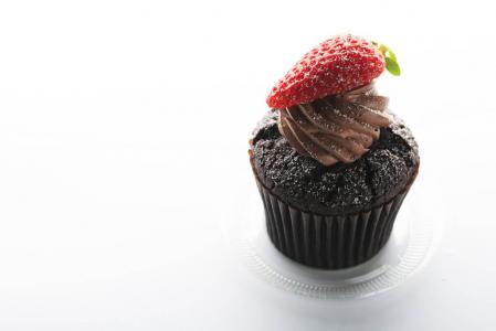 黑色蛋糕顶着巧克力和草莓